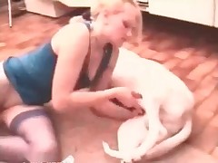 Clothed blonde plays with her shepherd